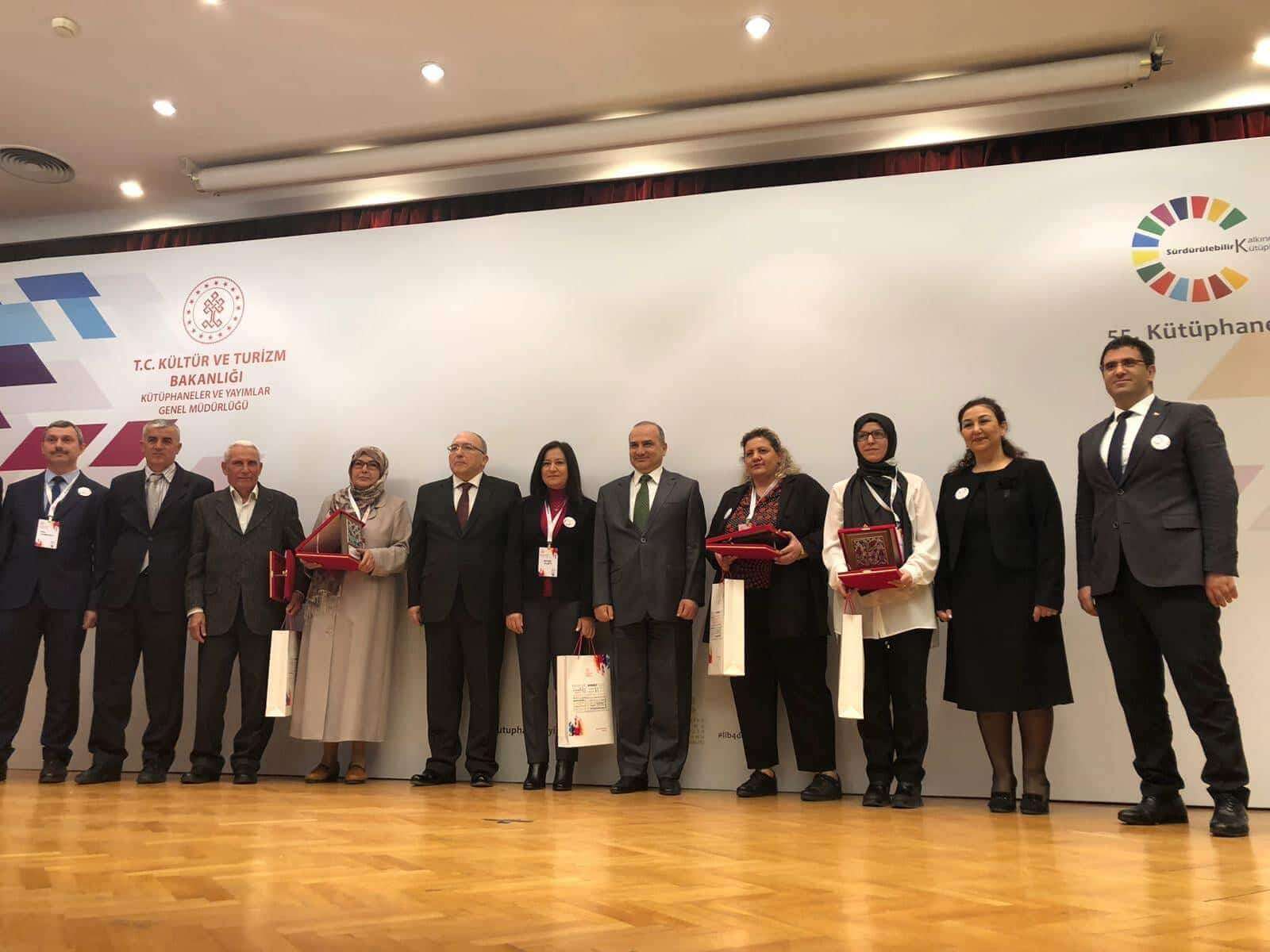 Kütüphane Haftası'nda ödül töreninde sahnede duran bir grup.
